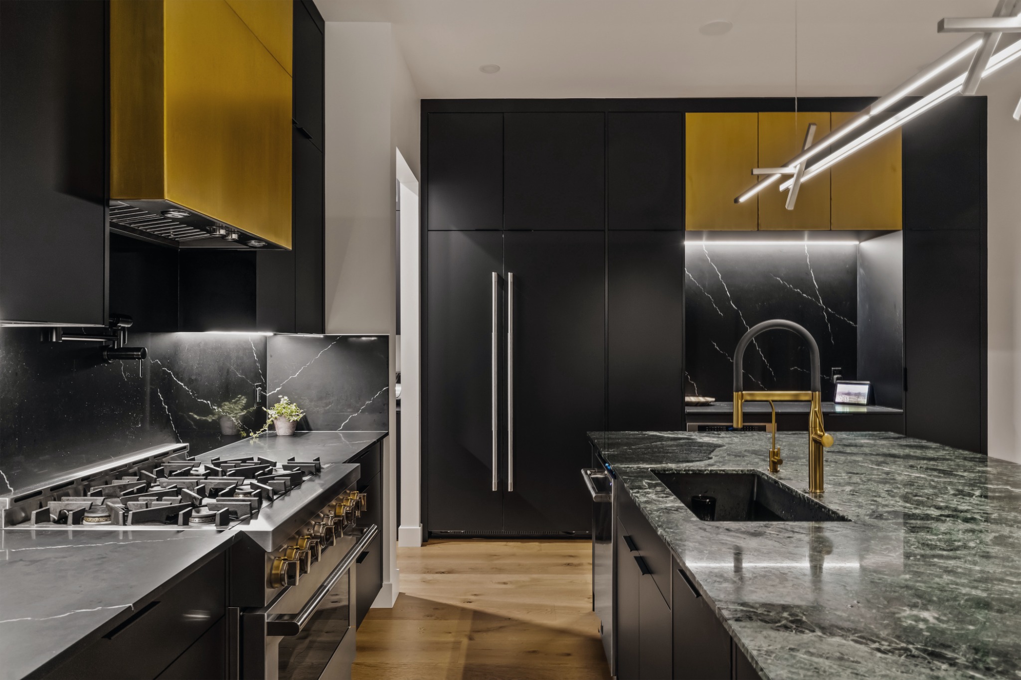 Kitchen with dark cabinetry and natural stone island