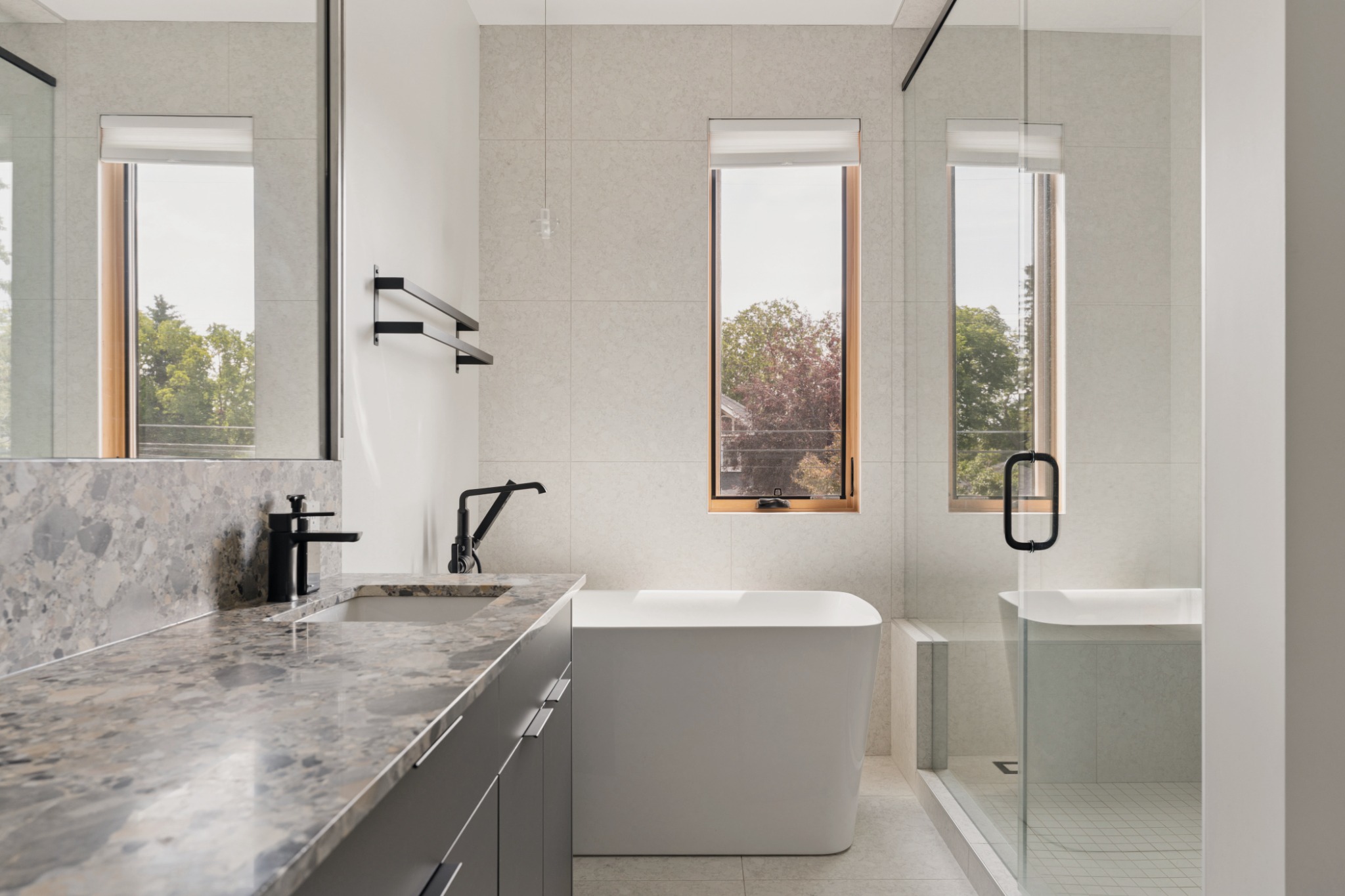 Ensuite bathroom with stone vanity and freestanding tub